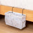 Bedside storage bag with metal hooks, featuring multiple pockets for holding items like books and snacks. Available at Shopway.