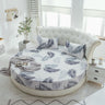 Round bed with leafy patterned bedspread and pillows, featuring Shopway's quality cotton hotel mattress protector.