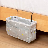 Alt Tag: High-capacity canvas bedside storage bag with multiple pockets and metal hooks, ideal for storing essentials. Shopway product.