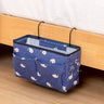 Blue canvas bedside storage bag with whale pattern, featuring multiple pockets and hooks for organizing essentials. Available at Shopway.