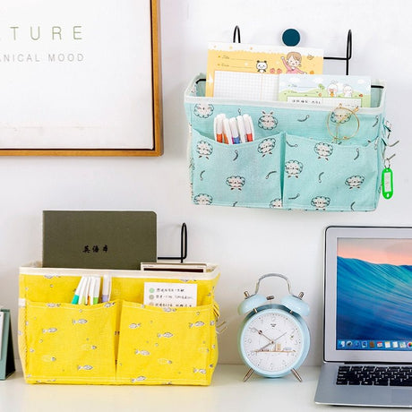 Stylish bedside storage bags in yellow and blue, featuring multiple pockets for books, stationery, and more. Available on Shopway.