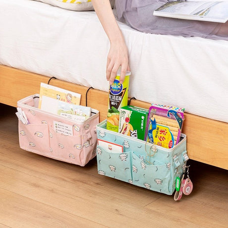 Colorful bedside storage bags with multiple pockets for books, snacks, and essentials, featuring high-quality canvas and metal hooks. Shopway product.