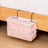 Pink canvas bedside storage bag with hooks, featuring multiple pockets for books, phone, and accessories. Available at Shopway.