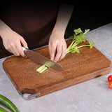 Person cutting celery on octagonal wooden chopping board, available at Shopway. Durable, mold-resistant design. Sizes: 40*27*3CM.