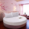Round white cotton bed sheet and mattress protector set on round bed in stylish hotel room - Shopway