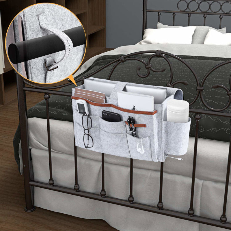 Grey bedside felt storage bag hanging on bed with multiple pockets for organizing bedroom items. Shopway product showcasing simple, modern design.