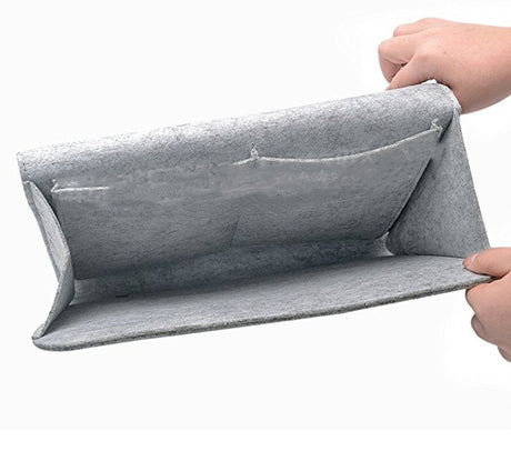 Person holding open gray felt storage bag for bedside or sofa, available at Shopway.